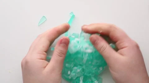 Tiny turquoise soap pieces broken apart, showcasing their soft texture and a Stock Footage 311060584