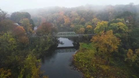 Tiny two lane bridge from drone on foggy morning with amazing autumn Stock Footage 245977505