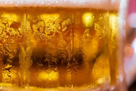 Tiny water droplets condense on a beer glass meant to cool you down in the .. Stock Photos