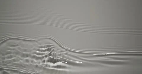 Tiny water waves sparkle in gentle light 4K Loop Stock Footage 335156272