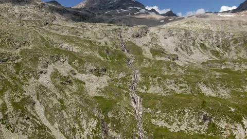 Tiny waterfall falling over stone rocks in austrian alps Stock Footage 224550409