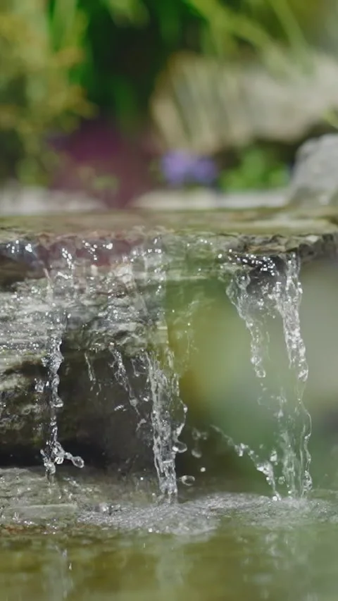 Tiny waterfall with large stone and pond in summer park Vídeos de archivo 309706791