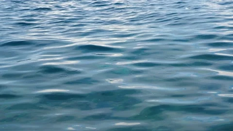 Tiny waves on the calm sea. The surface of the sea is very smooth. Blue clear 動画素材 153742544