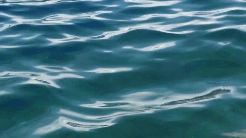 Tiny waves on the calm sea. The surface of the sea is very smooth. Blue clear 動画素材 153742867