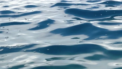 Tiny waves on the calm sea. The surface of the sea is very smooth. Blue clear 動画素材 153743088
