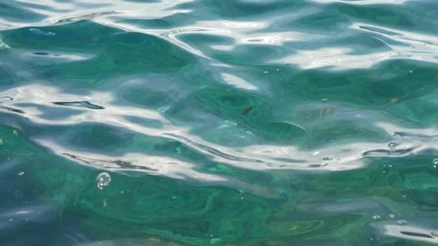 Tiny waves on the calm sea. The surface of the sea is very smooth. Blue clear 動画素材 153743951