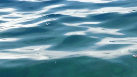 Tiny waves on the calm sea. The surface of the sea is very smooth. Blue clear 動画素材 153745020