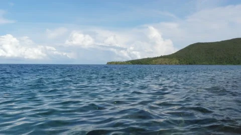Tiny waves on the calm sea. The surface of the sea is very smooth. Blue clear 動画素材 153745274