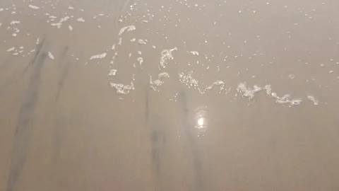 Tiny Waves of sea the sand of sea beach with reflection of sun in the water 스톡 동영상 331114494