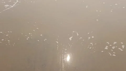 Tiny Waves of sea the sand of sea beach with reflection of sun in the water 스톡 동영상 331114524