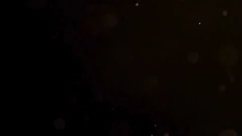 Tiny white dust specks drift through a black backdrop Stock Footage 329597960