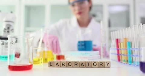 Tiny wooden cubes arranged on table to form word LABORATORY Stock Footage 283762678