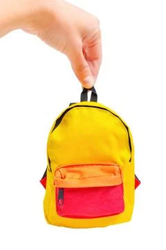 Tiny Yellow Backpack in Hand on White Stockfoto's