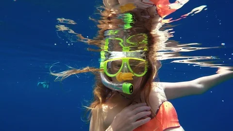 Tiny yellow jellyfish with face of caucasian girl snorkeling in background Stock Footage 94382954