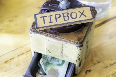 Tip box with Thai money inside Stock Photos