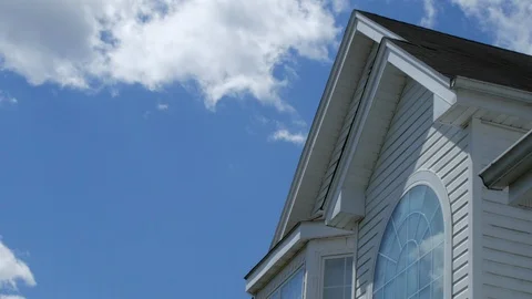 Tip of house clouds time lapse blue sky Stock Footage 107246184