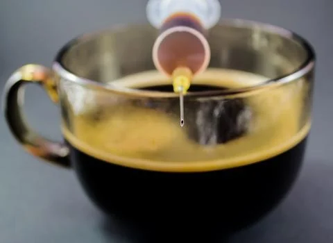 Tip of a Hypodermic Needle and Coffee Stock Photos