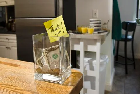 Tip jar in home kitchen Stock Photos