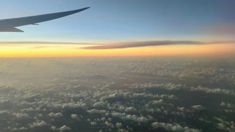 Tip of plane wing sunset light clouds in the air Stock Footage 221594563