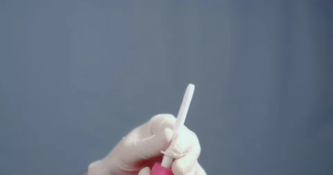 A tip is put on the pear enema. Stockbeeldmateriaal 169493089