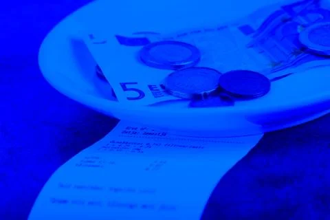Tip on a restaurant table. Blue toned. Фото