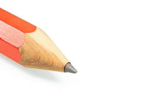 The tip of a sharpened red pencil close-up on a white background Stock Photos