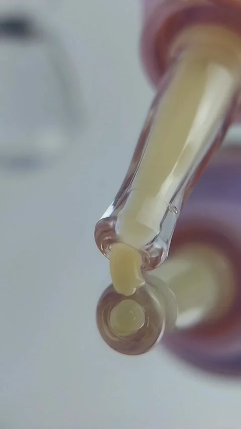 The tip of the tool dispensing yellow cream. Very close-up vertical view. Stock Footage 329787814