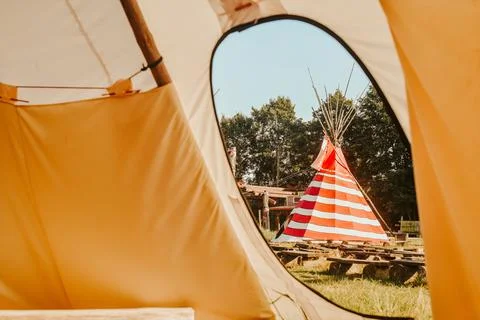 Tipi house in the forest against the background of trees, camping, village in Stock Photos