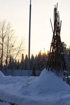 Tipi posts stuck in the thick snow in the middle of winter surrounded by lush Stock Photos