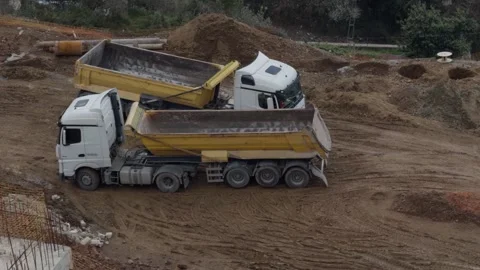 Tipper Dump Trucks Standing Side by Side on Construction Site Stockbeeldmateriaal 335944893