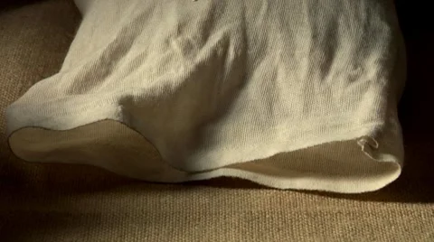 Tipping brown rice out of a sack Stock Footage