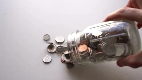 Tipping coin jar Stock Footage 288494211