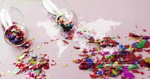 Tipping two clear vials spilling metallic confetti on pale pink table with Stock Photos