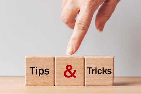 Tips and Tricks concept. written on wooden blocks, tips and tricks to help .. Stock Photos