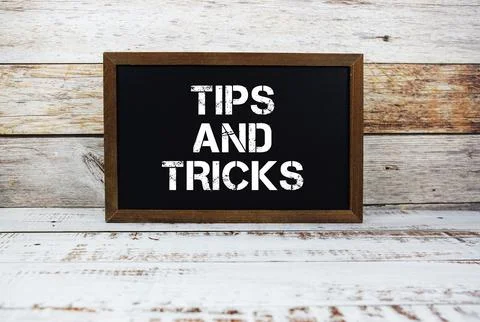 Tips and Tricks typography text on wooden blackboard Stock Photos