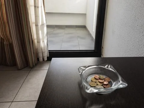 Tips in the ashtray on a hotel table Stock Photos