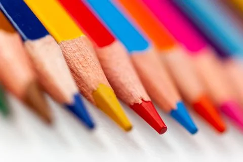 The tips of colored pencils on a white background, close-up Stock Photos