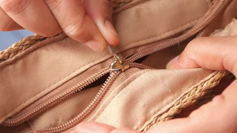 Tips for fixing a stuck zipper on a bag Stock Footage 330147463