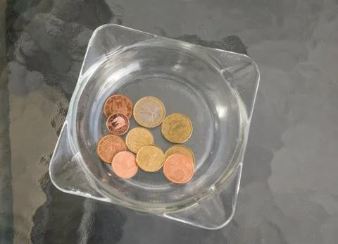 Tips left in the ashtray at a glass table Stock Photos