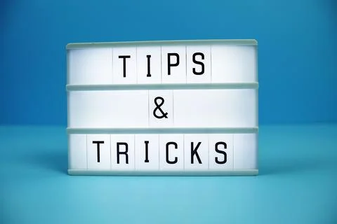 Tips &amp; Tricks letterboard text on LED Lightbox on blue background Stock Photos