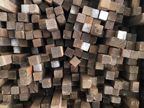 Tips of wooden boards placed in a pattern in a timber warehouse. Wood concept Stock Photos