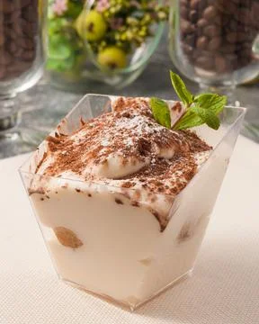 Tiramisu dessert in a rectangular container decorated with mint Stock Photos