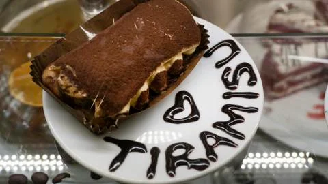 Tiramisu dessert with the word tiramisu written with chocolate Stock Photos