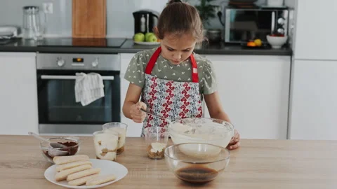 Tiramisu making process in the kitchen- little girl making Italian desert with c Stock Footage 246009861