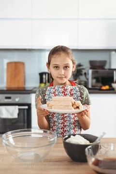 Tiramisu making process in the kitchen- little girl making Italian desert w.. Stock Photos