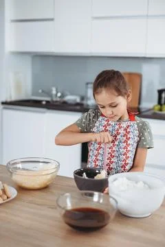 Tiramisu making process in the kitchen- little girl making Italian desert w.. Stock Photos