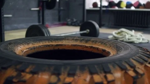 Tire and Barbell in Empty Gym Stock Footage