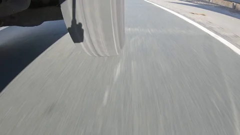 Tire and wheel low angle driving at high speed on highway POV Stock Footage 123924836