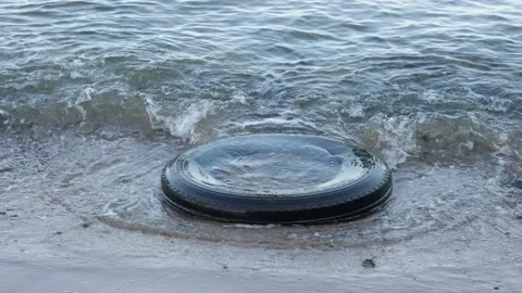 Tire on the beach causing pollution Video stock 160968045
