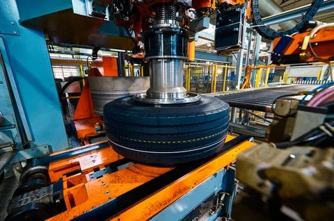 Tire with deep protector and marking on conveyor at plant Stock Photos